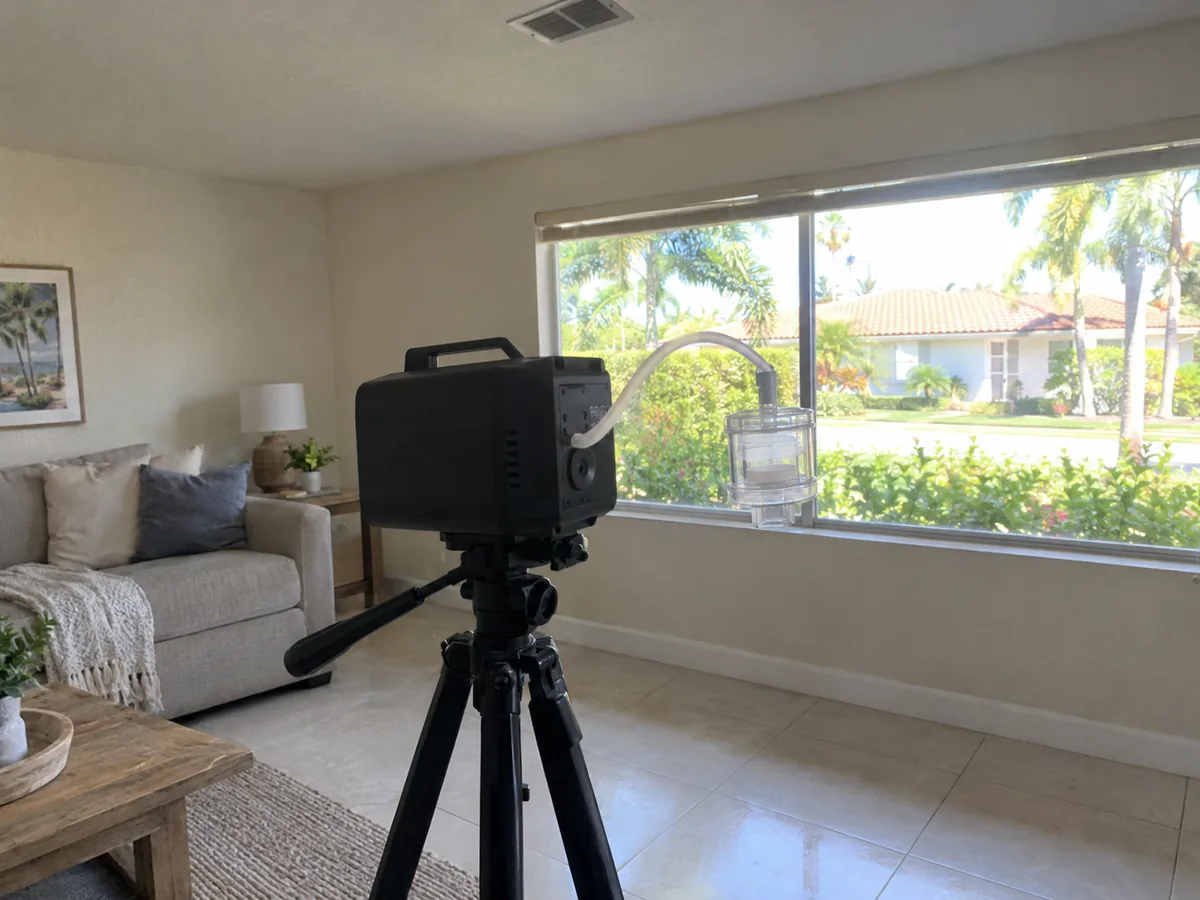 Air sampling pump taking a mold test in a West Palm Beach living room